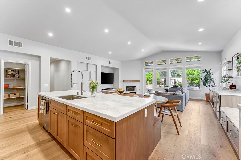 2269 Shady Oaks Road Glendora, CA 91741 - Photo 20 of 62 a large kitchen with kitchen island a sink a stove a dining table and chairs
