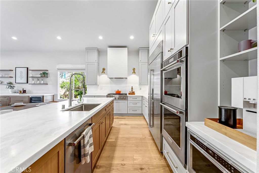 2269 Shady Oaks Road Glendora, CA 91741 - Photo 21 of 62 a large kitchen with stainless steel appliances kitchen island granite countertop a large counter top a stove a chimney a sink and a refrigerator
