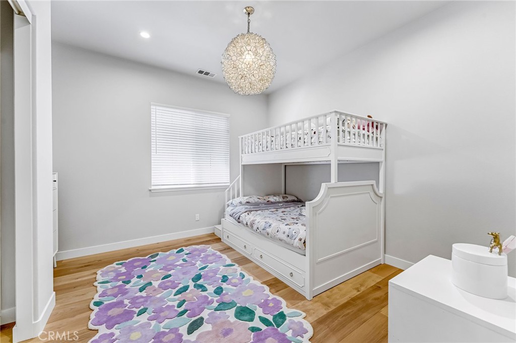 2269 Shady Oaks Road Glendora, CA 91741 - Photo 29 of 62 a bedroom with a bed and a chandelier