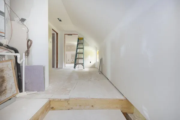 a view of a hallway with stairs and wooden floor