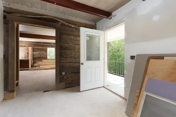 a view of an empty room and glass door