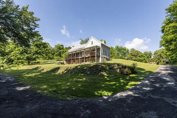 an aerial view of a house with a yard and garden