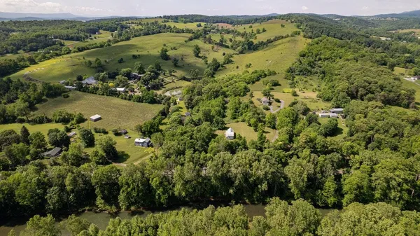 an aerial view of a house with a yard and outdoor seating
