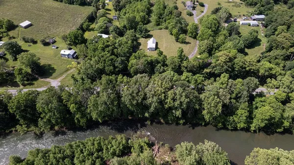 an aerial view of a house with a yard and trees