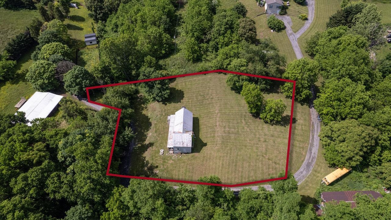 13573 Cooley Spring Lane Broadway, VA 22815 - Photo 51 of 63 an aerial view of a house with a yard and trees