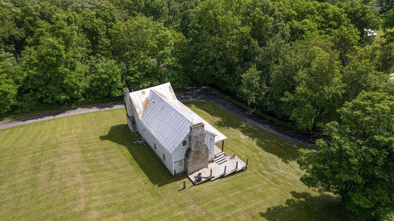 13573 Cooley Spring Lane Broadway, VA 22815 - Photo 57 of 63 a view of a swimming pool with lawn chairs under an umbrella