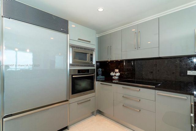 a kitchen with a sink and white cabinets
