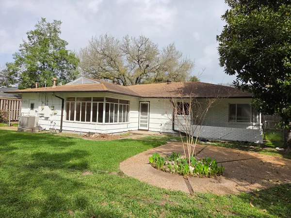 a front view of a house with a yard table and chairs