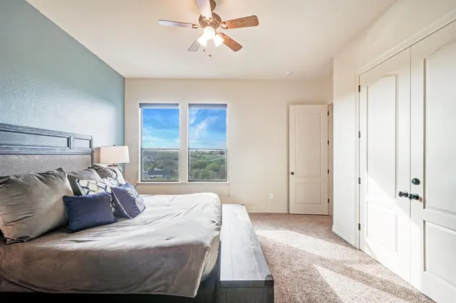 a view of a city from a balcony with furniture