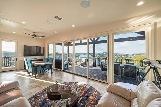 a living room with furniture tv and a large window