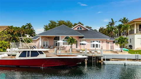 a view of a house with pool and chairs