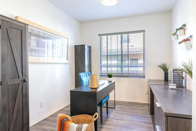 a view of a room with furniture window and wooden floor