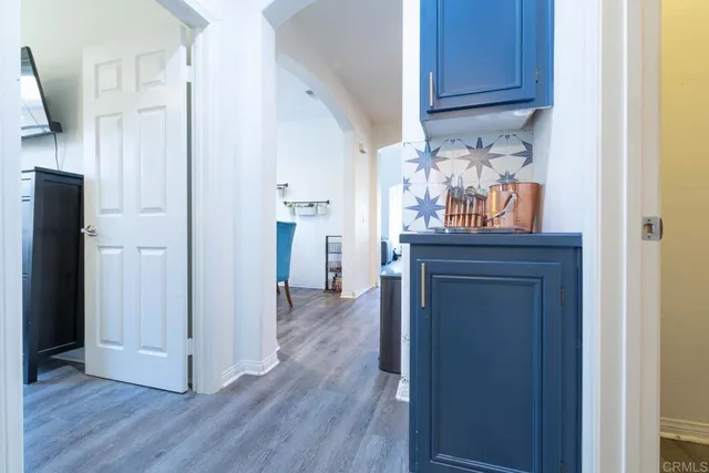 a view of a kitchen with wooden floor and cabinets