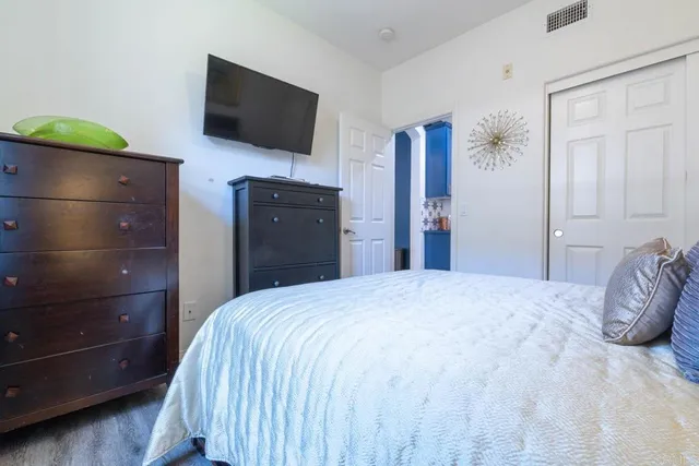 a bedroom with a bed and a flat screen tv