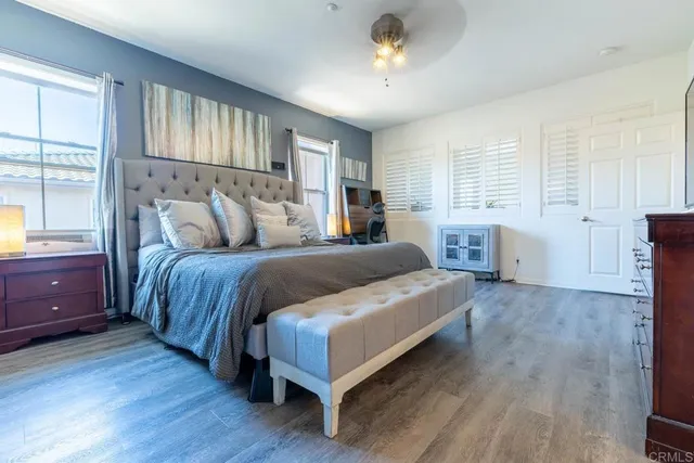 a bedroom with a large bed and a chandelier