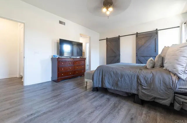 a bedroom with a bed and a television