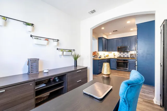 a open kitchen with stainless steel appliances granite countertop a refrigerator and a stove