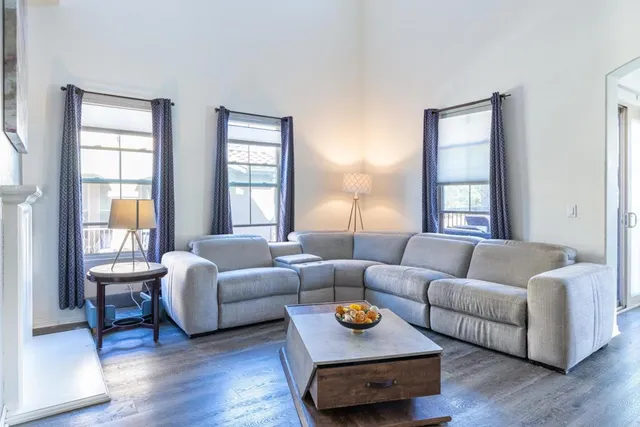 a living room with furniture and a wooden floor