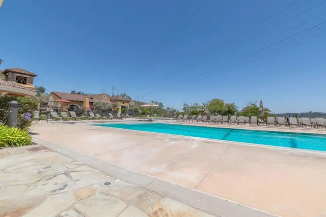 a view of a patio with chairs and plants