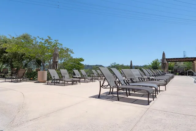 a view of a patio with a dining table and chairs with wooden floor