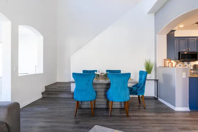 a view of a dining room with furniture a rug and wooden floor