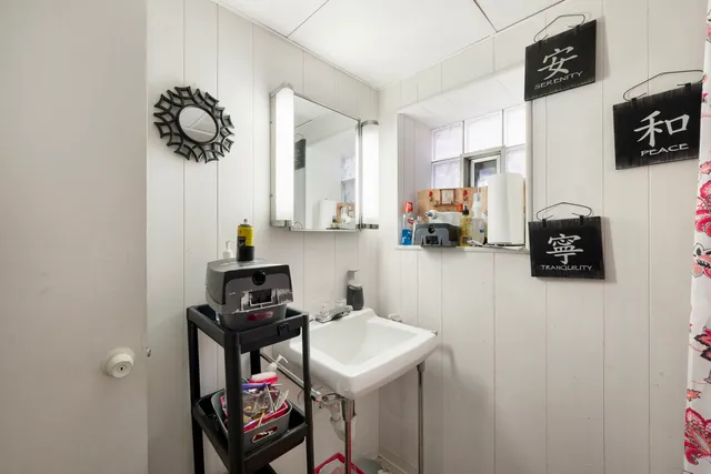 a living room with furniture and a blue curtain