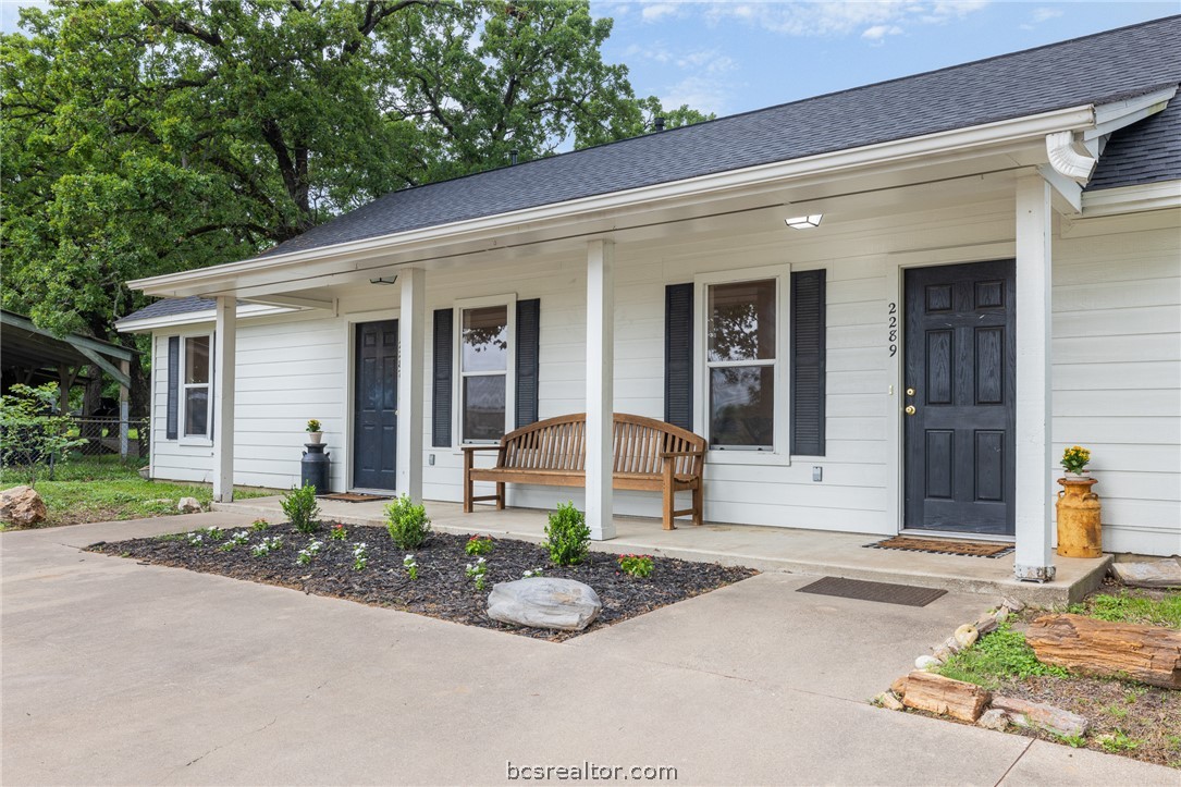 2287 North Earl Rudder Freeway Bryan, TX 77803 - Photo 9 of 32 a front view of a house with a yard and potted plants