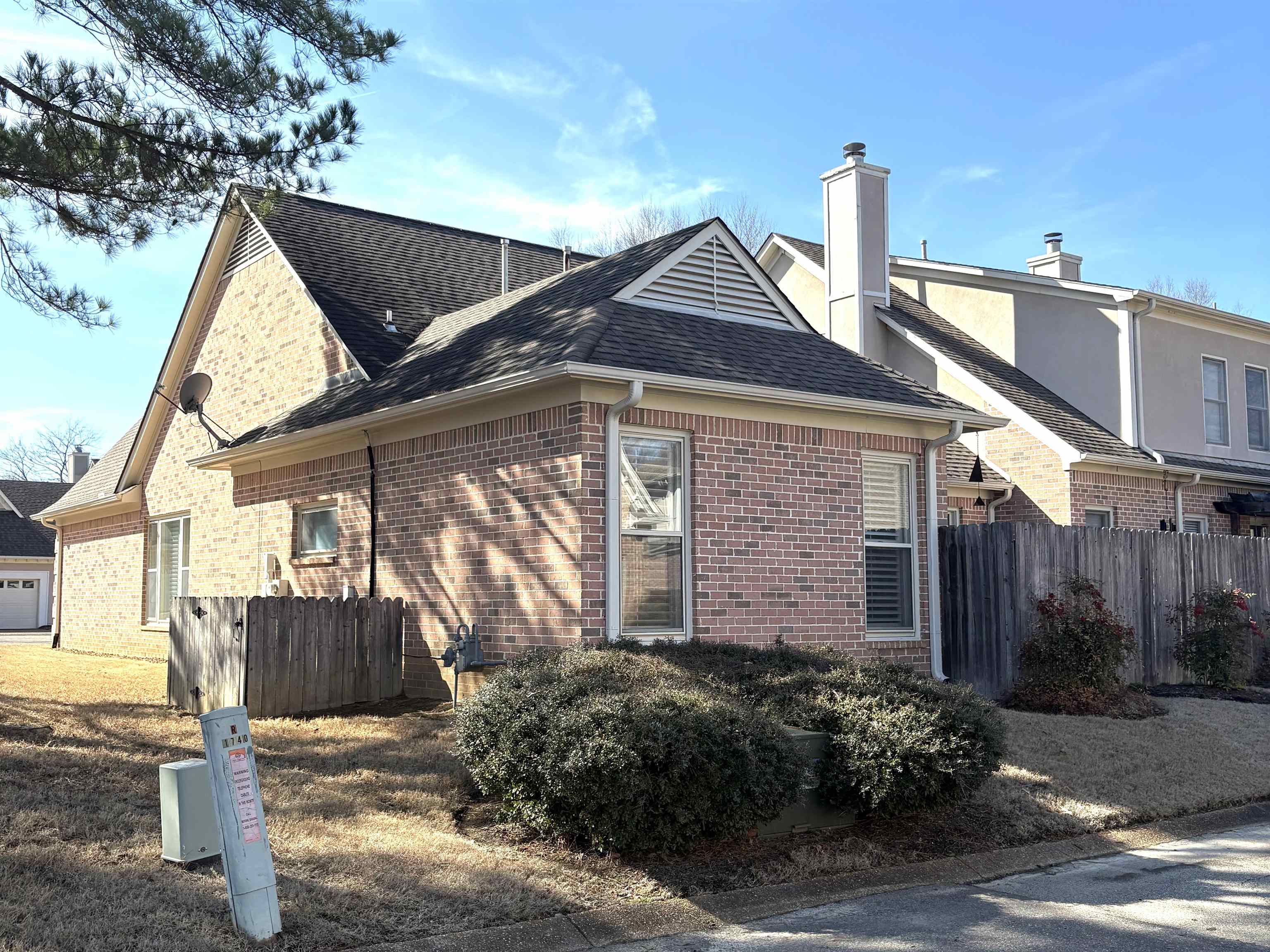 1740 Constable Court Collierville, TN 38017 - Photo 15 of 17 View of property exterior featuring roof with shingles, brick siding, and a chimney