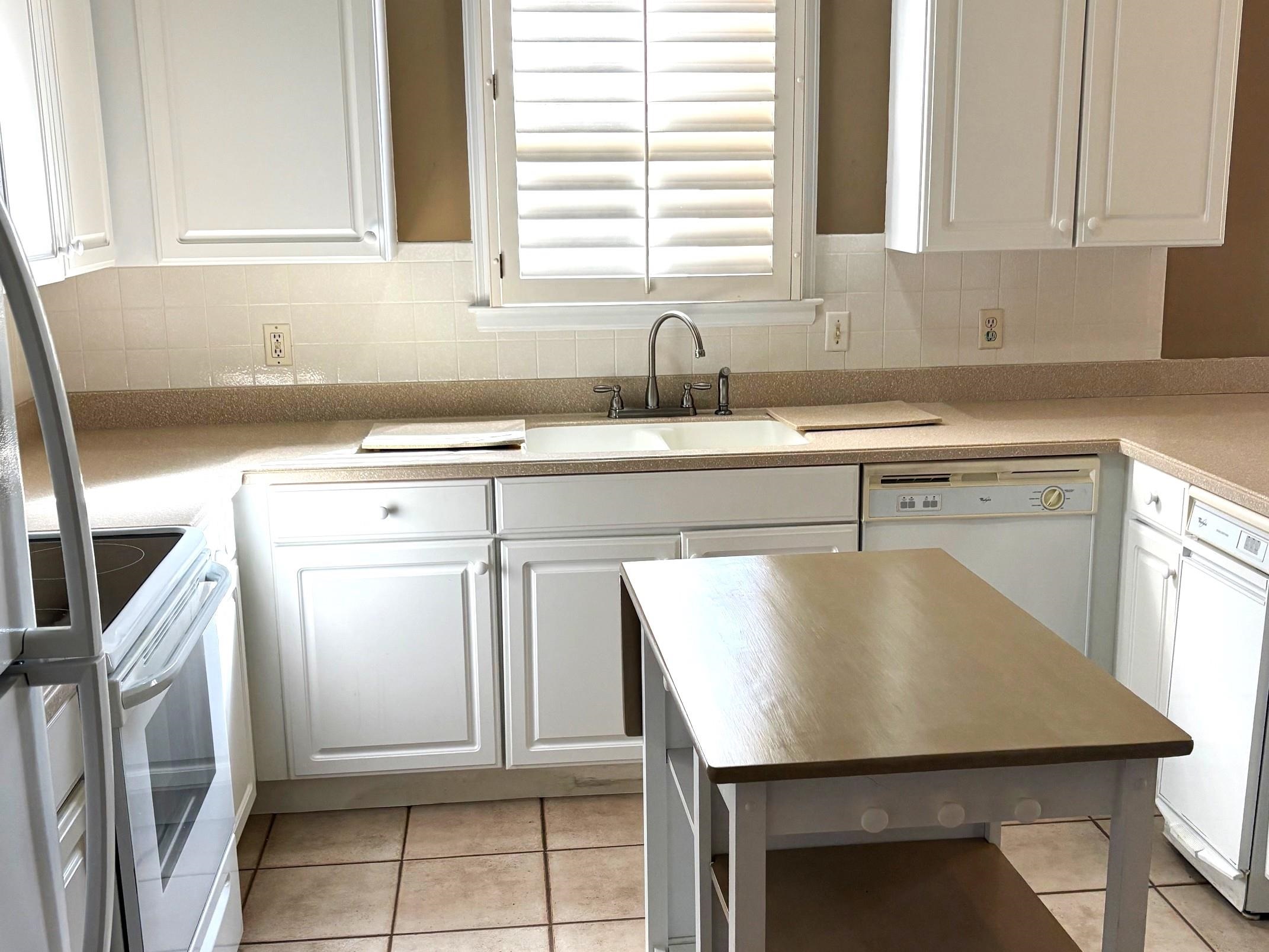 1740 Constable Court Collierville, TN 38017 - Photo 5 of 17 Kitchen with white cabinetry, white electric stove, light tile patterned flooring, freestanding refrigerator, and decorative backsplash