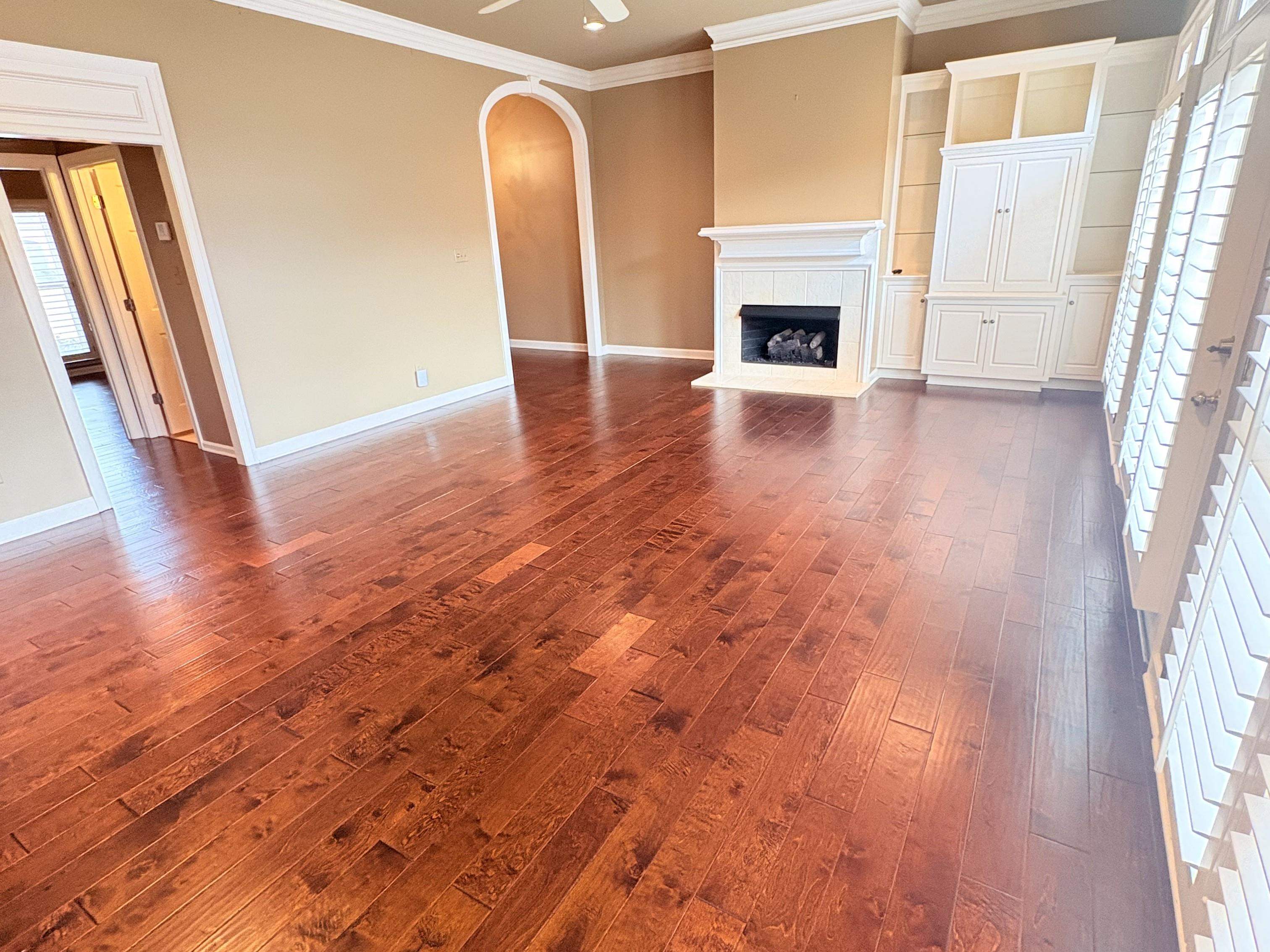 1740 Constable Court Collierville, TN 38017 - Photo 8 of 17 Unfurnished living room with ornamental molding, healthy amount of natural light, dark wood finished floors, and arched walkways