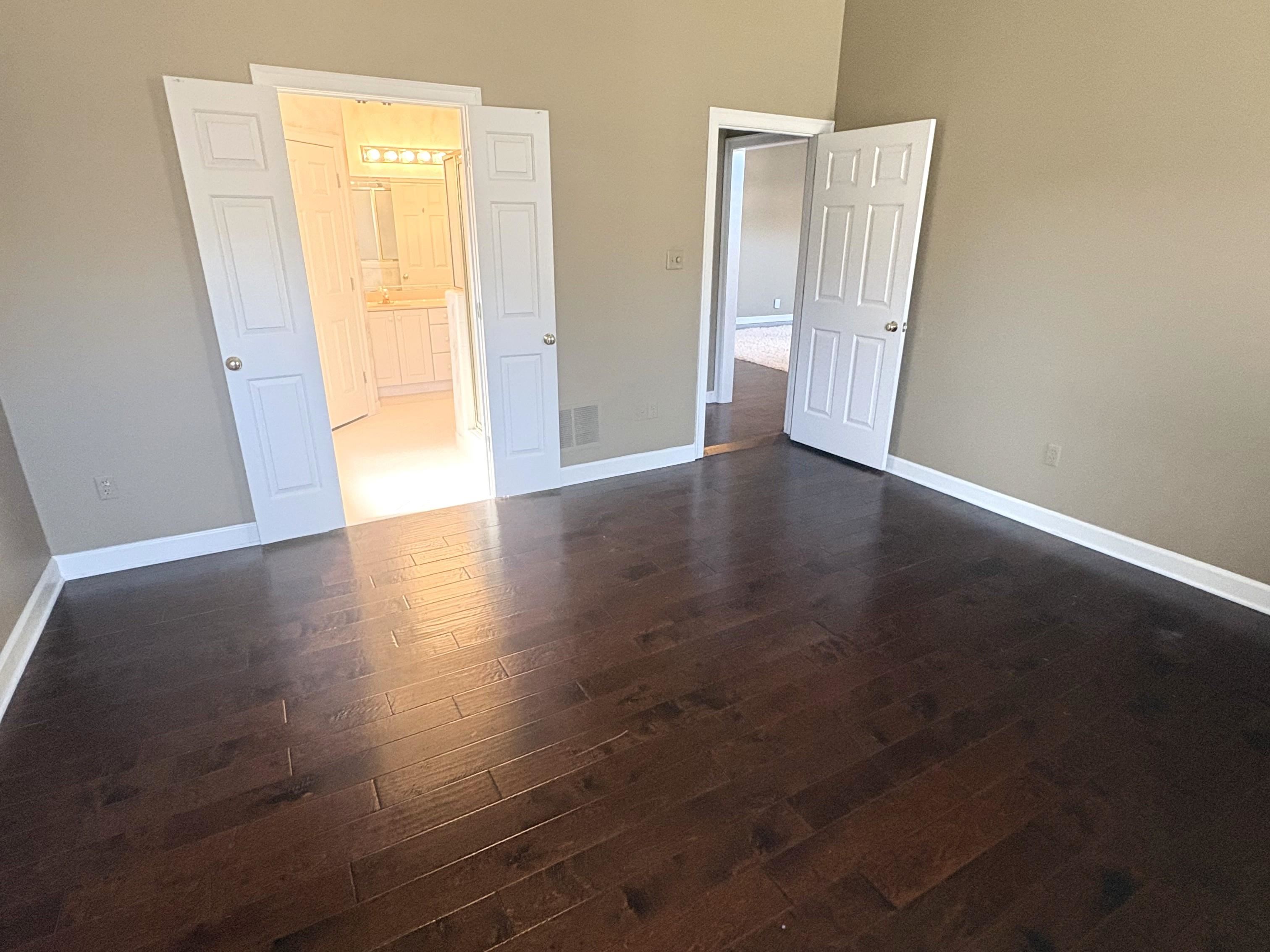 1740 Constable Court Collierville, TN 38017 - Photo 10 of 17 Primary bedroom with ensuite bath and wood flooring.