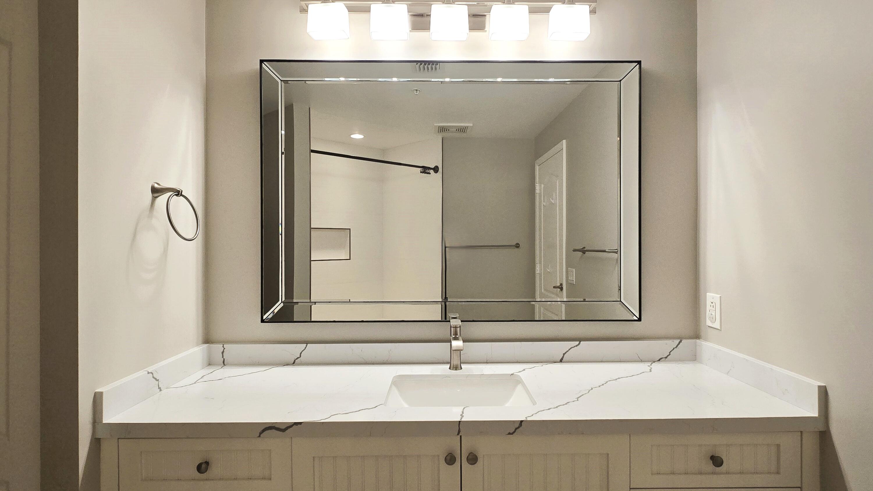 410 Evernia Street, Unit 701 West Palm Beach, FL 33401 - Photo 14 of 29 a bathroom with a sink and a mirror