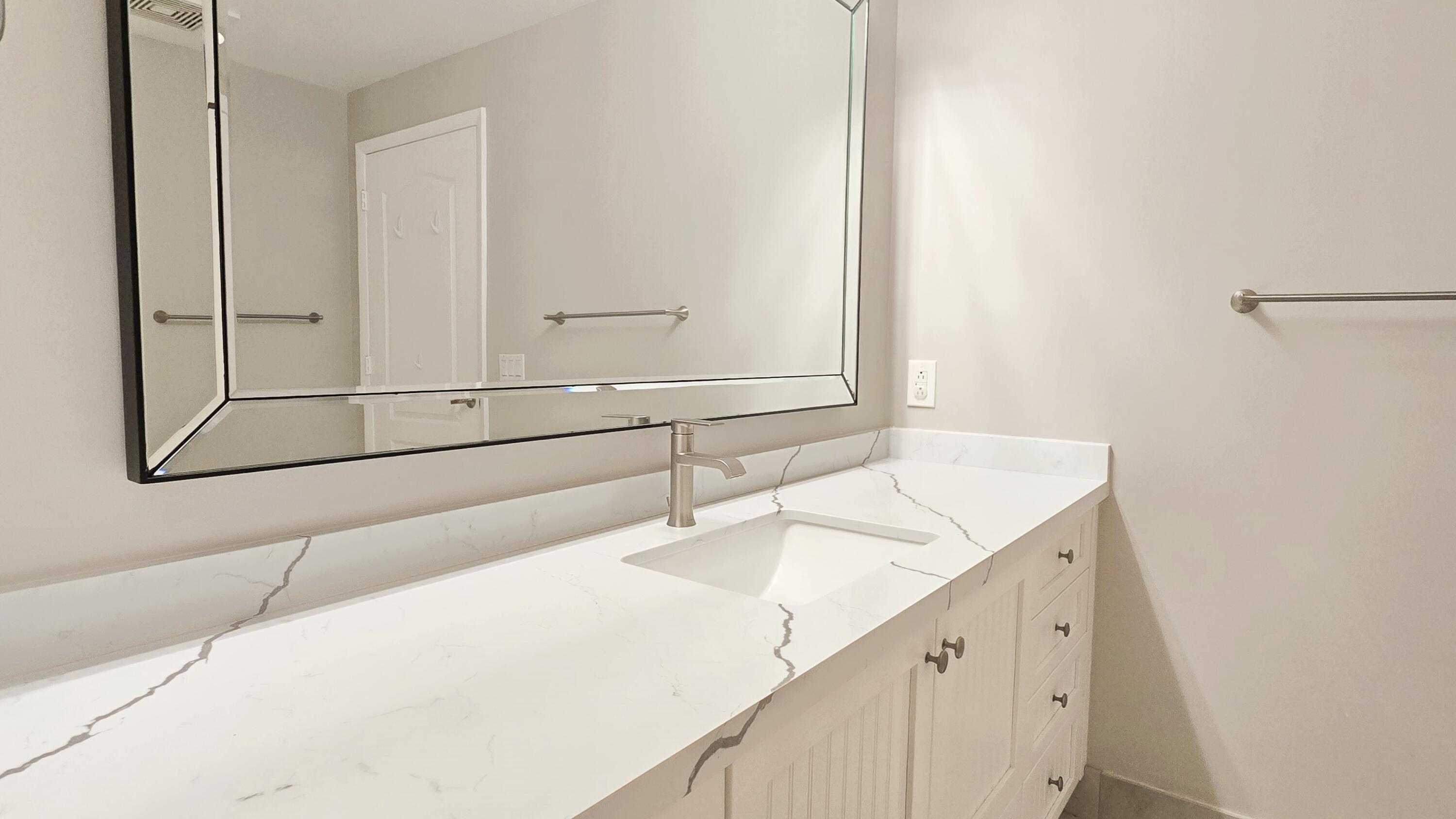 410 Evernia Street, Unit 701 West Palm Beach, FL 33401 - Photo 15 of 29 a bathroom with a sink and a mirror