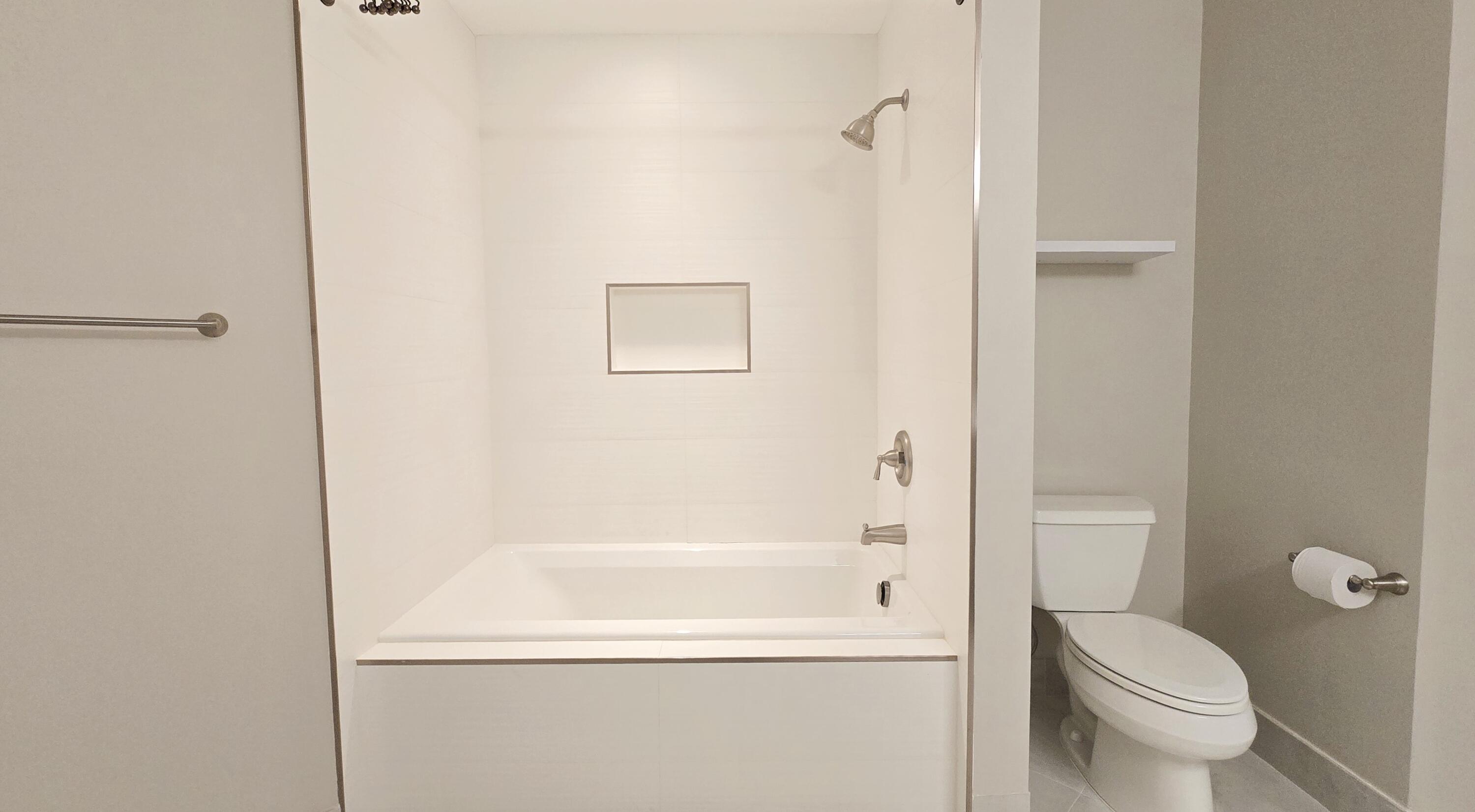 410 Evernia Street, Unit 701 West Palm Beach, FL 33401 - Photo 16 of 29 a bathroom with a toilet and a bathtub