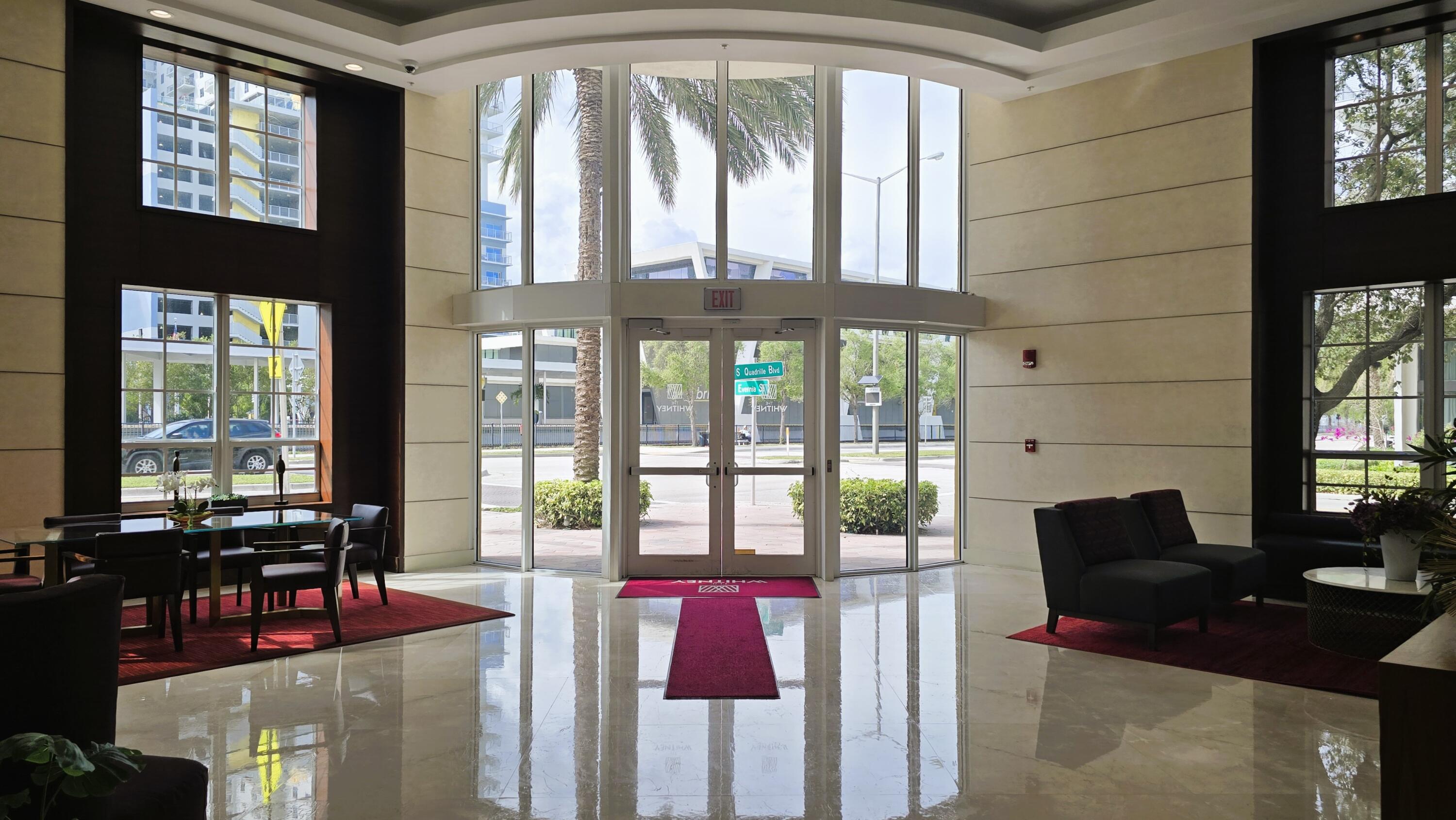 410 Evernia Street, Unit 701 West Palm Beach, FL 33401 - Photo 25 of 29 a living room with furniture and floor to ceiling windows