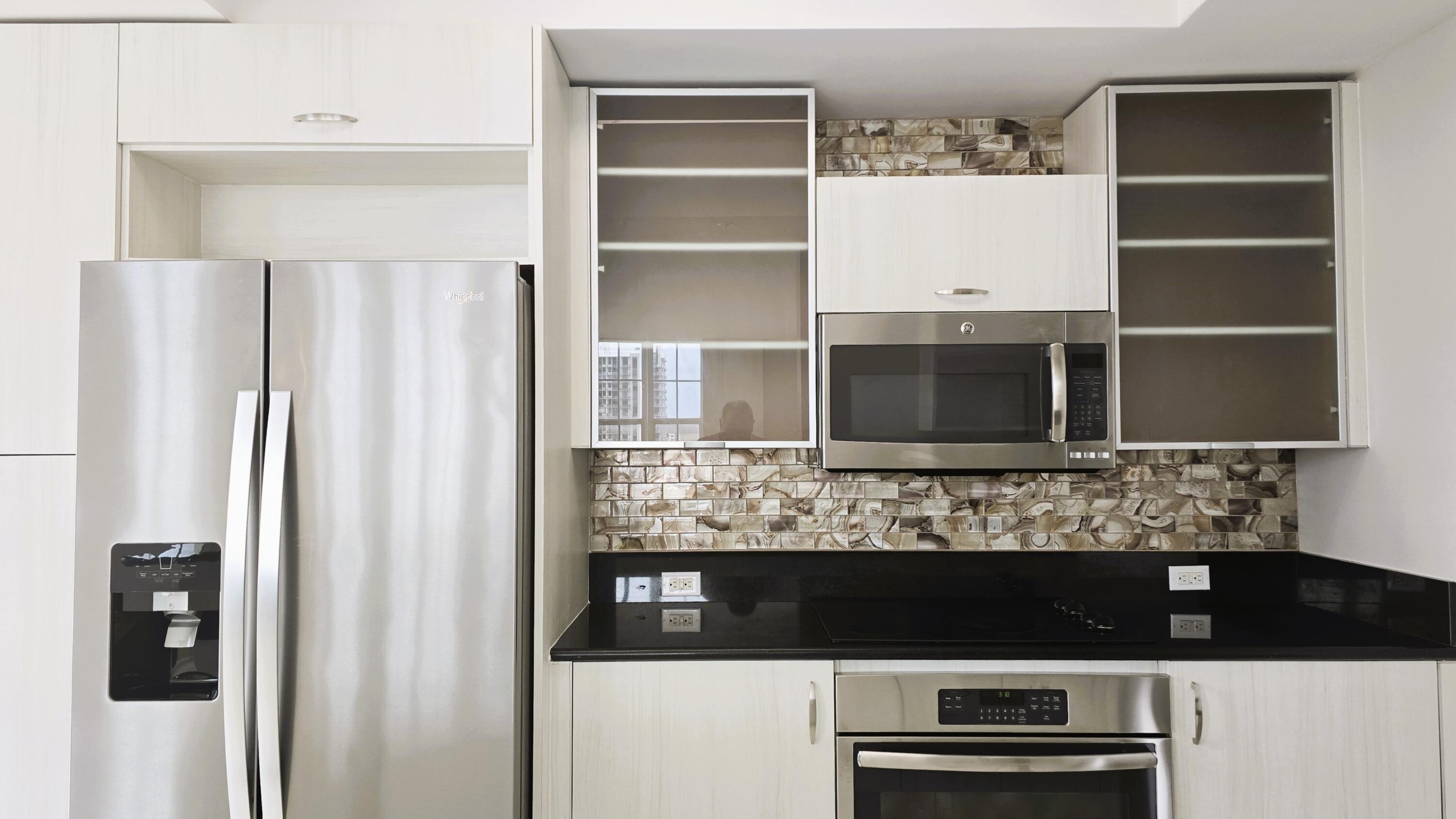 410 Evernia Street, Unit 701 West Palm Beach, FL 33401 - Photo 6 of 29 a view of kitchen with a refrigerator and cabinets