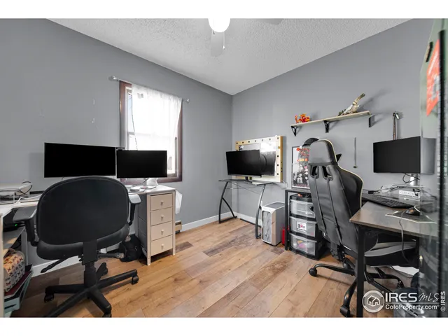 a view of a workspace with furniture and a flat screen tv