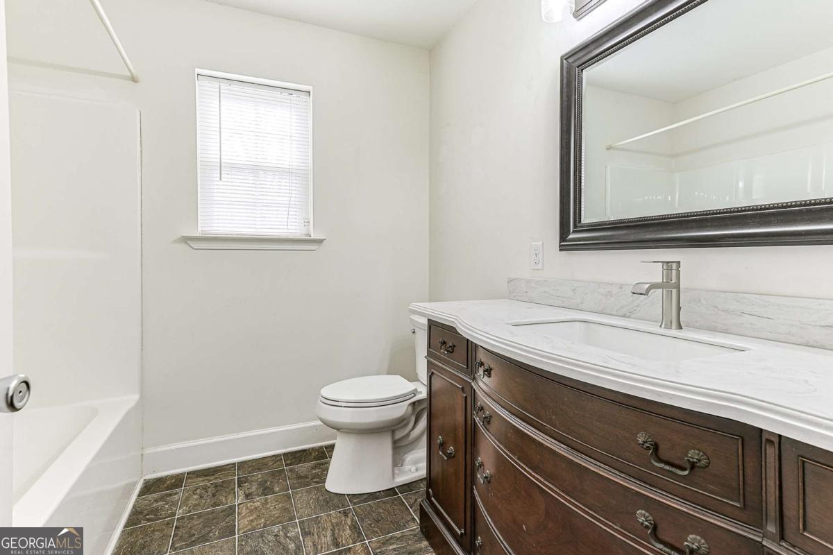 30 Chancel Circle, Unit 654R Ellijay, GA 30540 - Photo 34 of 44 a bathroom with a toilet sink and mirror