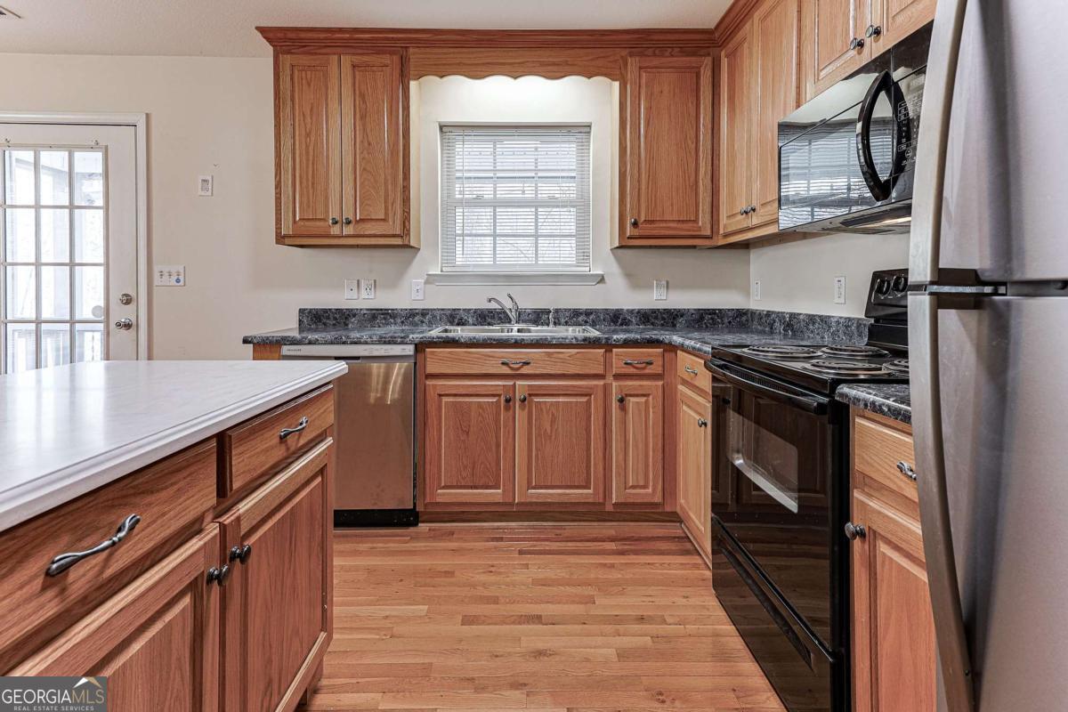 30 Chancel Circle, Unit 654R Ellijay, GA 30540 - Photo 41 of 44 a kitchen with stainless steel appliances granite countertop a stove a sink dishwasher and a refrigerator