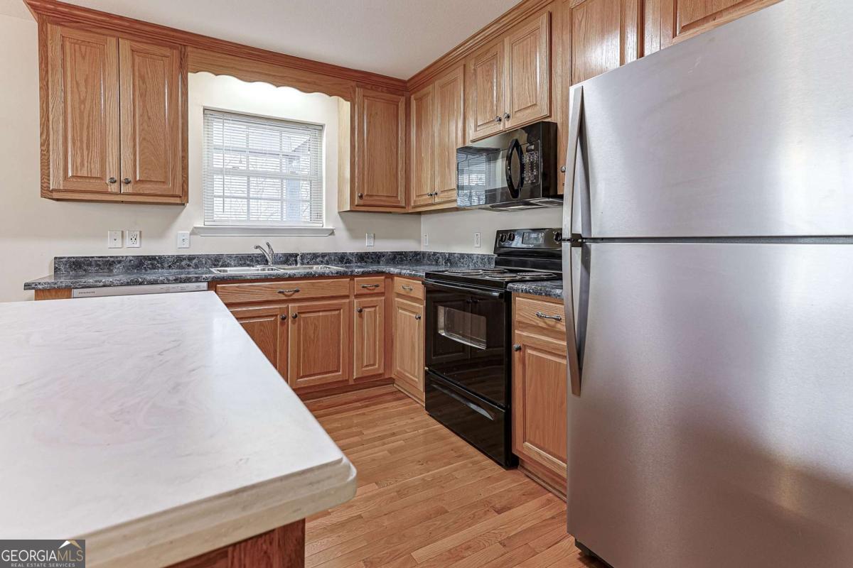 30 Chancel Circle, Unit 654R Ellijay, GA 30540 - Photo 42 of 44 a kitchen with stainless steel appliances granite countertop a refrigerator sink stove microwave and cabinets