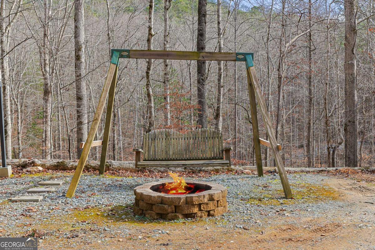 30 Chancel Circle, Unit 654R Ellijay, GA 30540 - Photo 8 of 44 a backyard of a house with trees and chairs