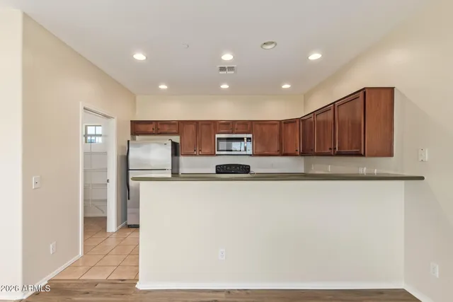 a kitchen with a refrigerator and a sink