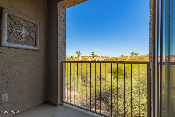 a view of a swimming pool with outdoor seating and plants