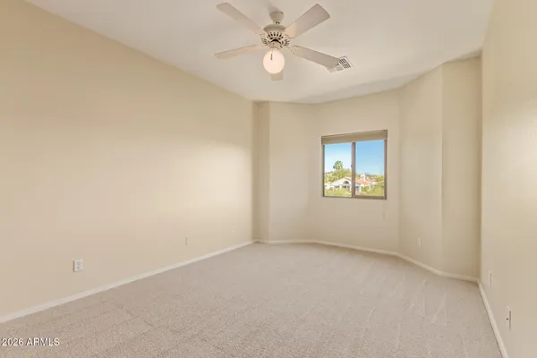 a bathroom with a granite countertop sink toilet mirror and a shower