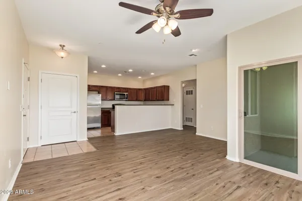 wooden floor in an empty room with a kitchen