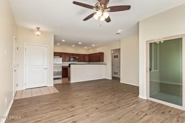 wooden floor in an empty room with a kitchen