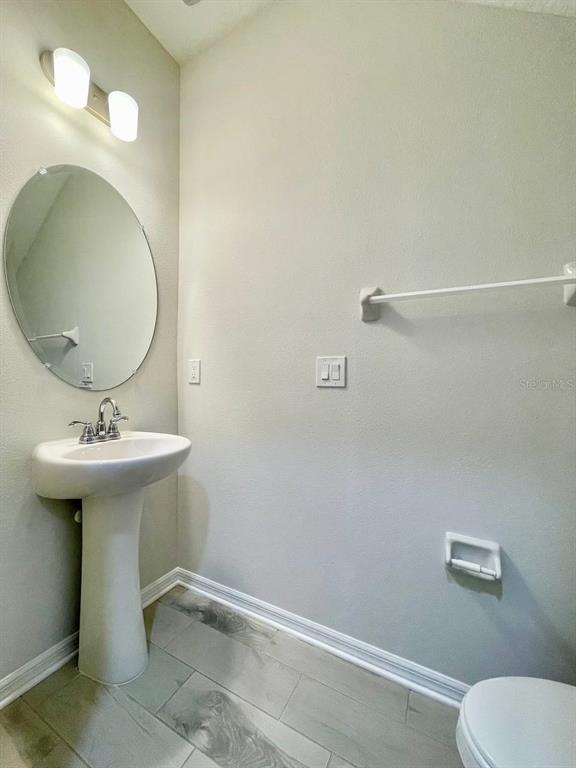 9689 Sweetwell Place Riverview, FL 33569 - Photo 12 of 33 a bathroom with a sink toilet and mirror