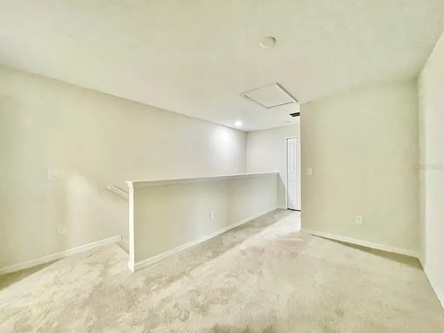 an empty room with a empty space and windows