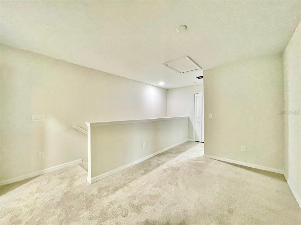 9689 Sweetwell Place Riverview, FL 33569 - Photo 13 of 33 an empty room with a empty space and windows