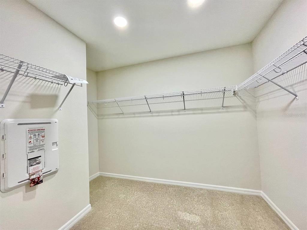 9689 Sweetwell Place Riverview, FL 33569 - Photo 18 of 33 a view of a room with racks on the wall